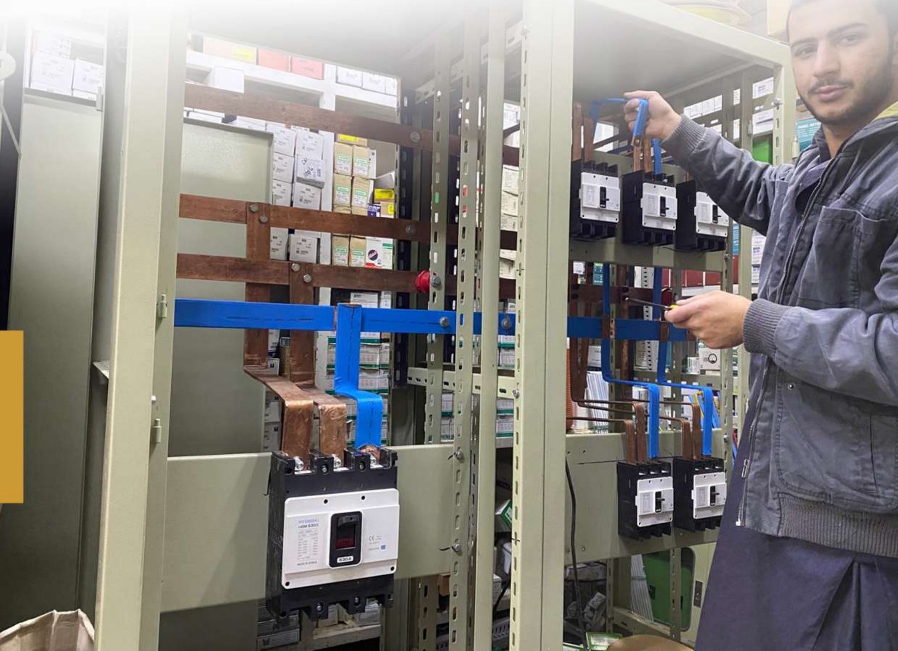 QMB technician at an electrical panel